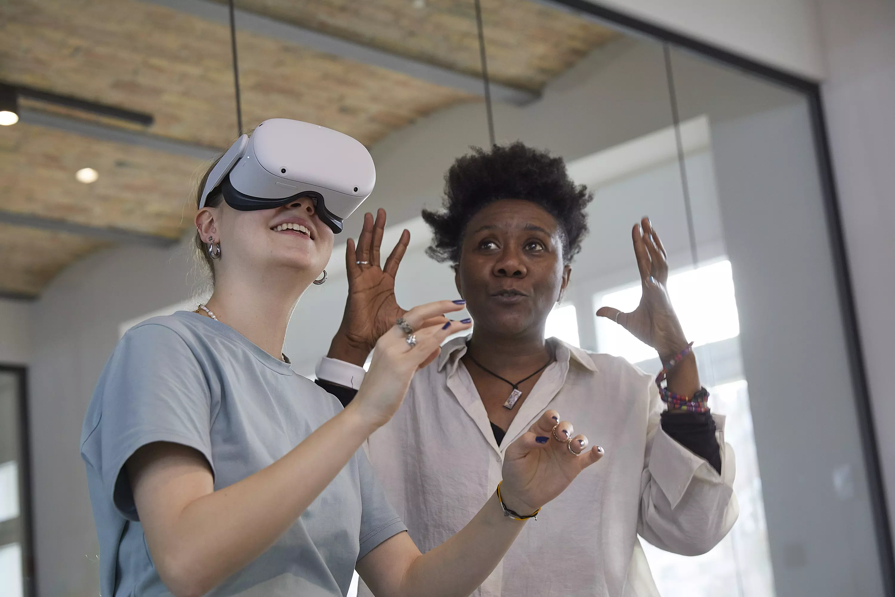 Eine futuristisch wirkende Szene zeigt eine Person in einer Art Tanz- oder Bewegungsperformance. Die Figur trägt ein körpernahes Outfit und ist von leuchtenden, ringförmigen Konstruktionen umgeben, die wie kinetische Skulpturen oder virtuelle Projektionen wirken. Der dunkle Raum und das dramatische Licht verstärken die abstrakte und maschinenhafte Ästhetik.