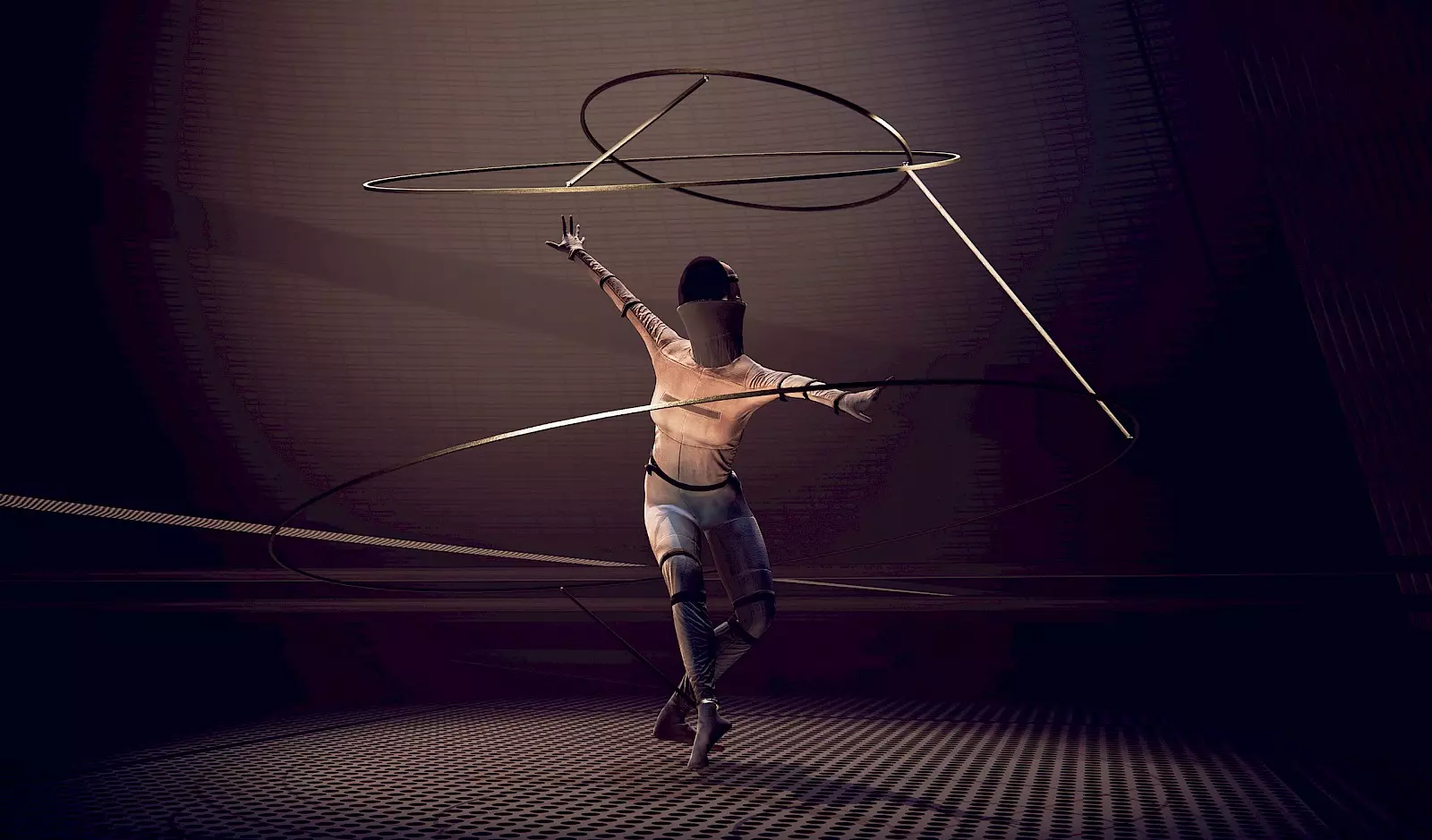 A futuristic-looking scene shows a person engaged in a dance or movement performance. The figure wears a form-fitting outfit and is surrounded by glowing ring-shaped structures that resemble kinetic sculptures or virtual projections. The dark space and dramatic lighting enhance the abstract and machine-like aesthetic.