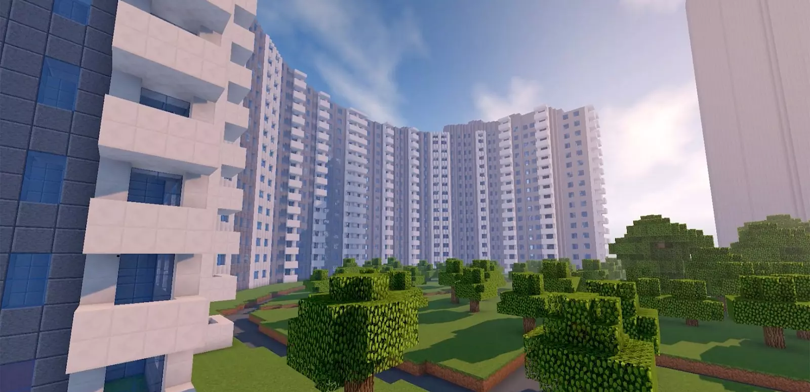 A Minecraft-designed digital city model depicts a large, semi-circular high-rise complex with many balconies and windows. In front of it lies a green park area with blocky trees under a blue sky.
