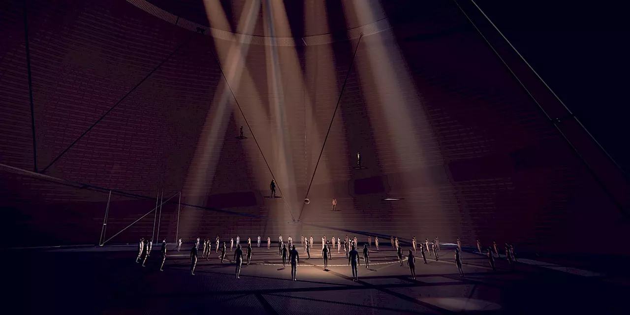 In a vast, dark domed space, numerous people stand in a circle as bright beams of light shine down from above. Figures are positioned on platforms along the walls, giving the scene a theatrical and almost futuristic atmosphere.